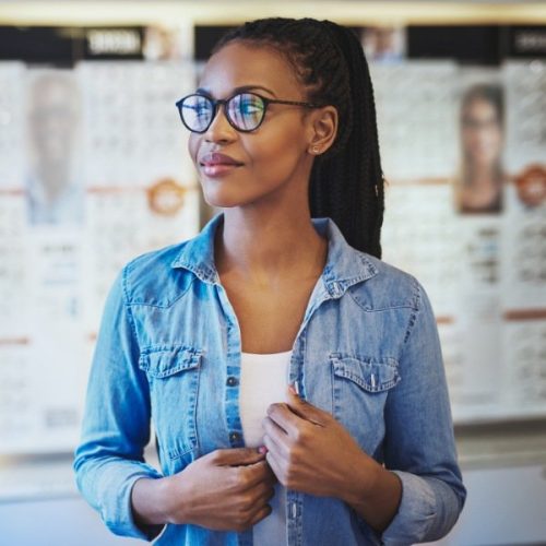 woman trying on glasses in an optical boutique